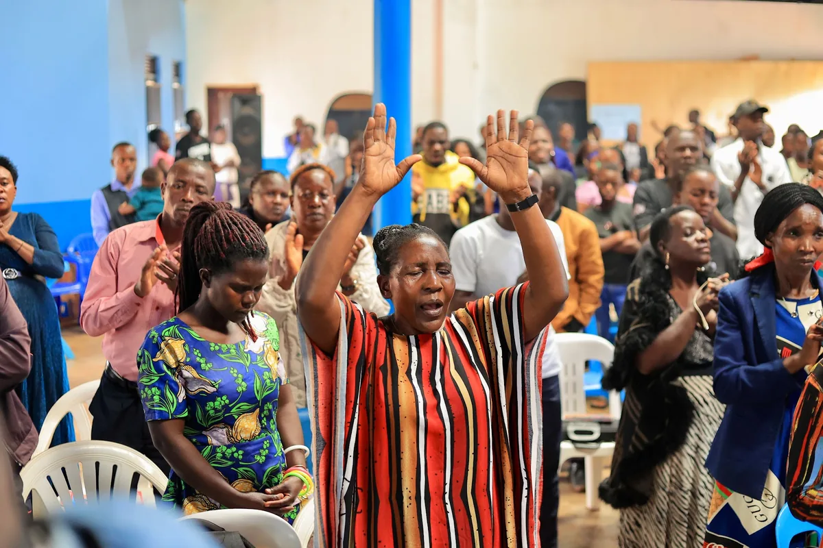 Members of the congregation with their hands raised