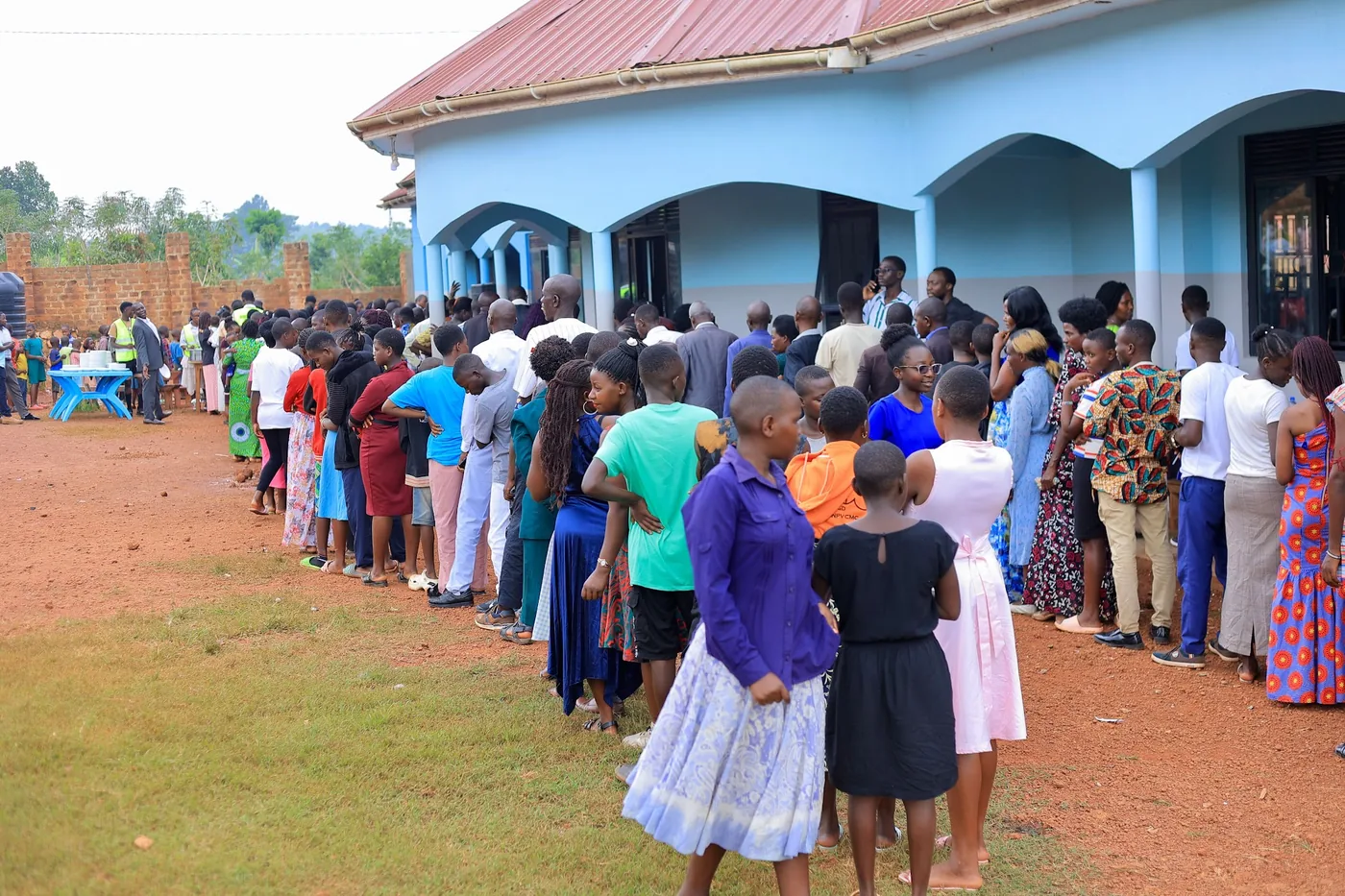 A long queue of people waiting outside the hall