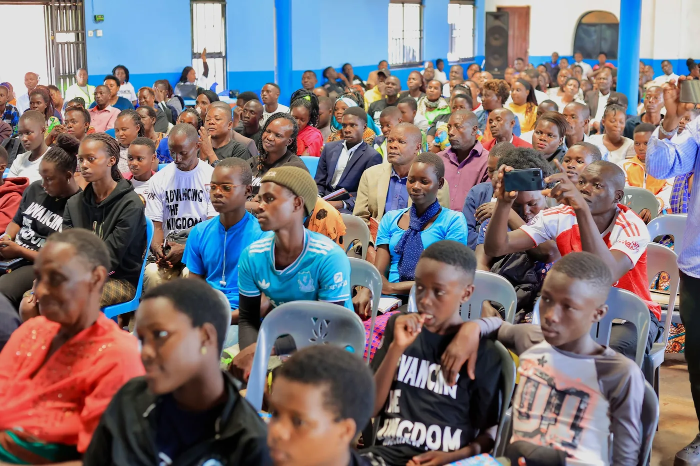 Young people seated and listening during a session