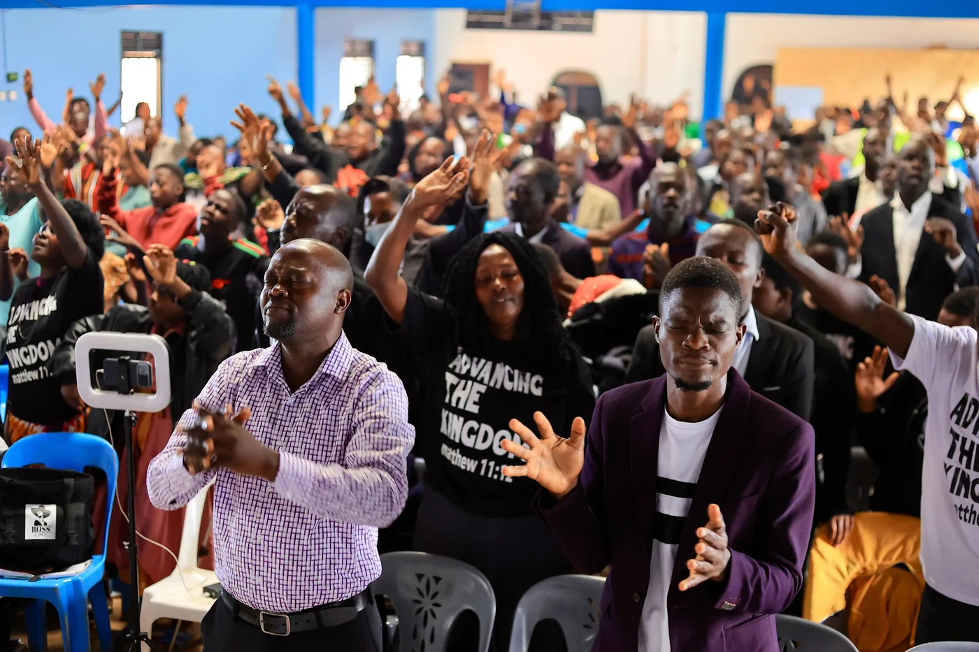 The congregation standing together in worship