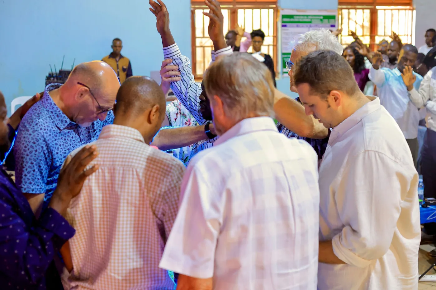 Members of the church praying together in a circle