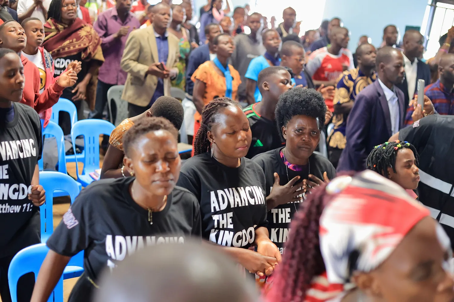 Members of the church worshipping together in ministry shirts