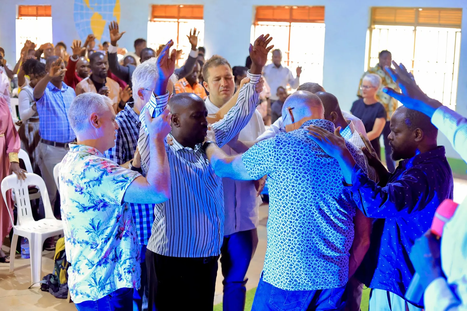 Members and visiting partners praying together